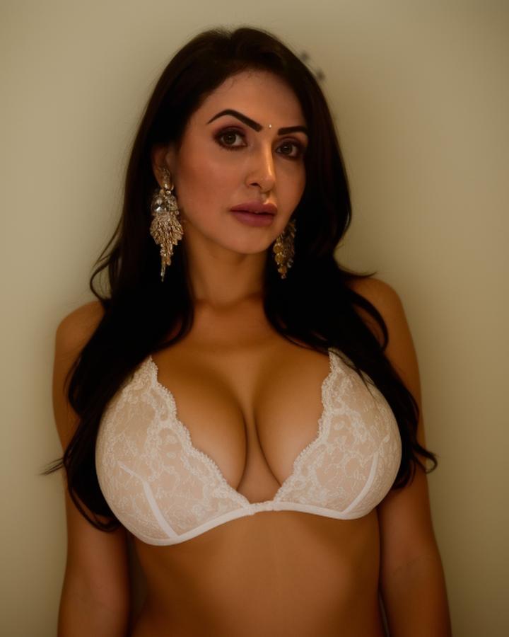 Nandini Rai cleavage busty white lace bra pose